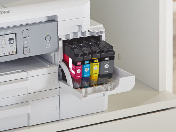 Man opening a Brother Genuine LC404 ink cartridge for printer