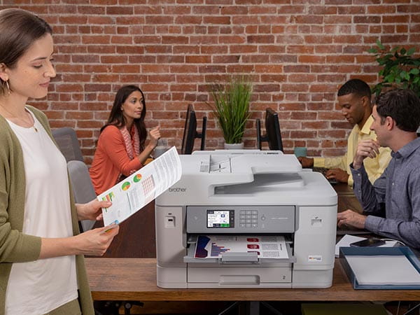 Woman in office reviewing printed document
