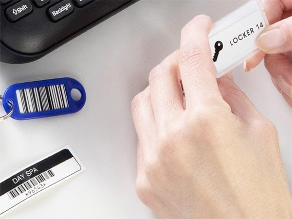 P-touch PTD460BT label maker on desk with locker keys with labeled key fob