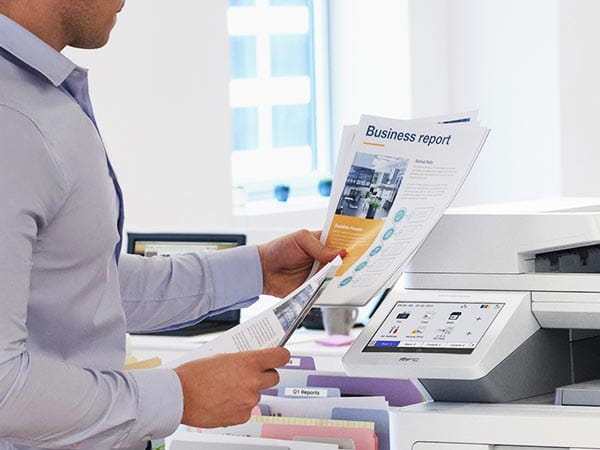 Person reviewing printed business report