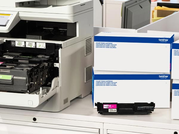 Laser printer in corporate office with boxes of replacement toner