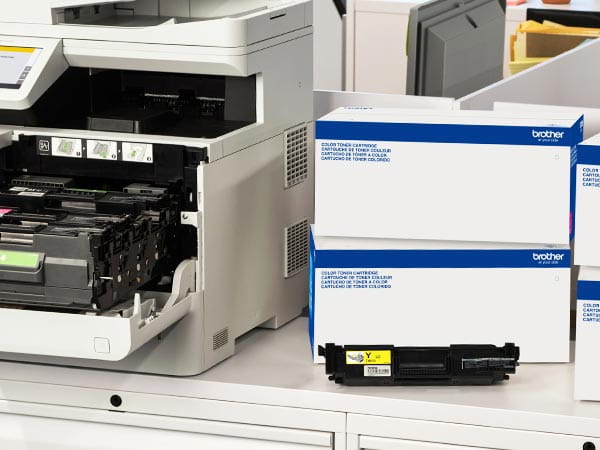 Laser printer in corporate office with boxes of replacement toner