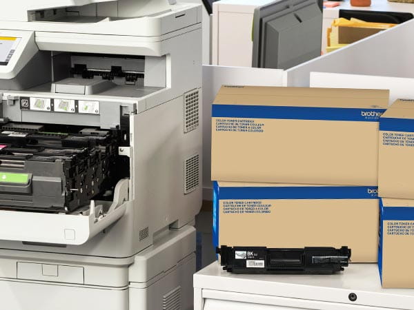 Laser printer in corporate office with boxes of replacement toner