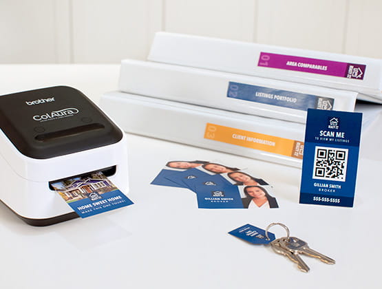 ColAura printer printing a label next to a stack of binders