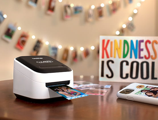 ColAura printer on side table in front of photo wall 