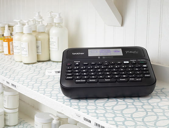 Ptouch PT-D610BT label maker on shelf with lotion bottles