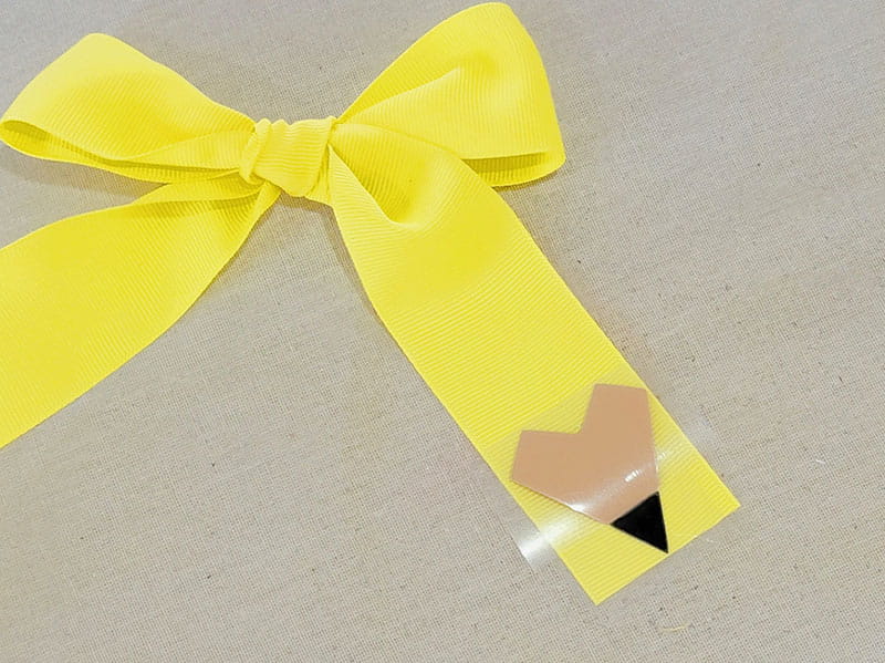 Pencil detail added to right side of yellow hair bow.