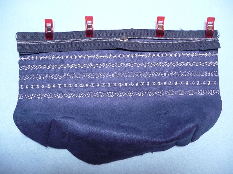Using clips to hold fold of fabric down