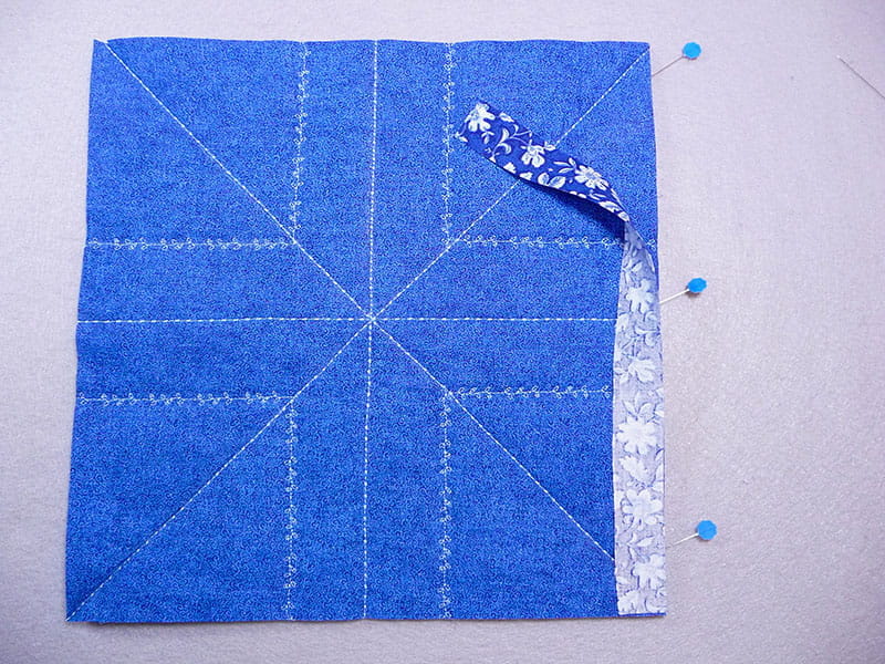 top view of the fabric and the edge pieces with pins holding them where they need to be stiched