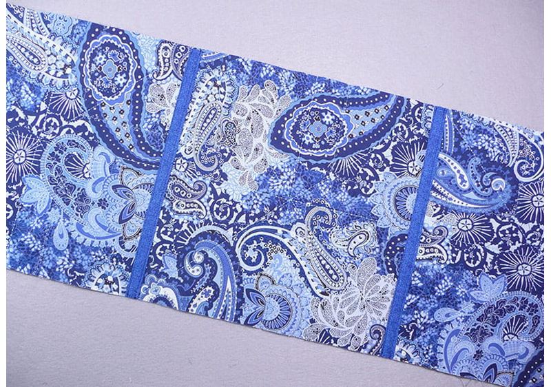 3 pieces of fabric sewn together in the edges displaying the 2 sides of fabric