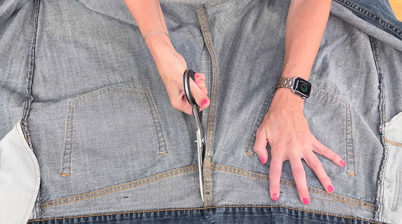 Cutting the back of a pair of jeans