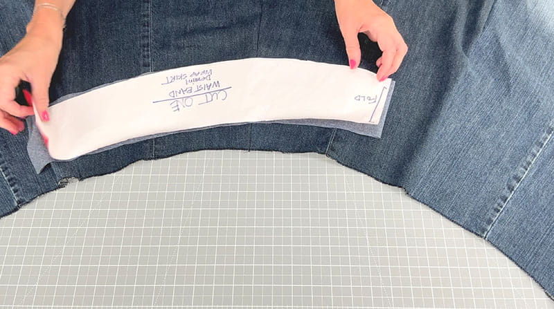 Measuring the waist span of the jeans for the project