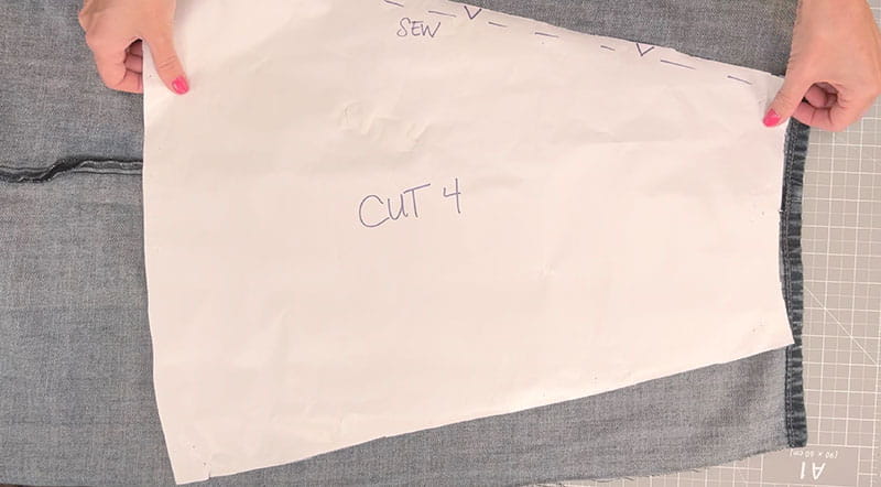Placing the sewing pattern on the jeans