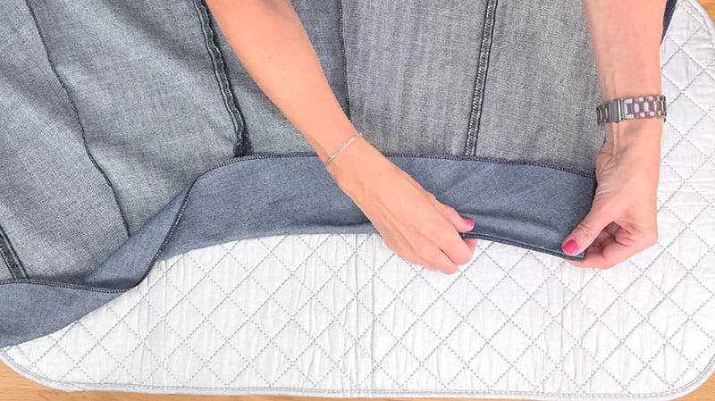 Lining up the edge to fold it on top of the fabric