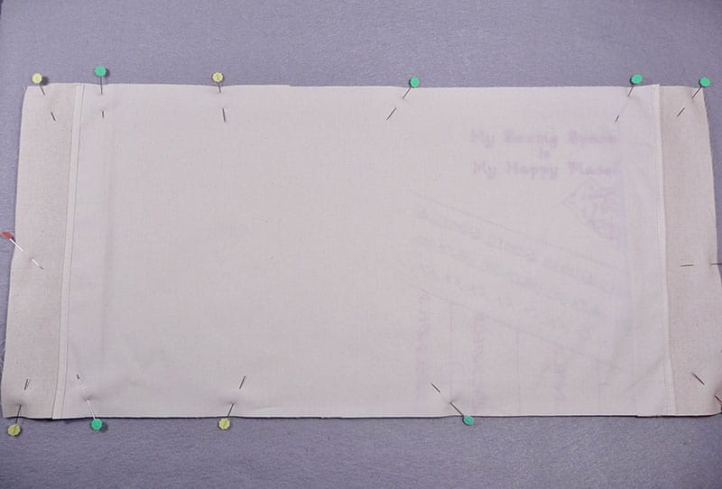 Fabric pinned to notebook cover.