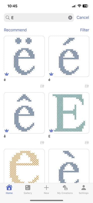 A phone screenshot of a cross-stitch design showing on the Artspira app featuring various letter "E" designs in different fonts and colors, such as blue and orange, with accents like diacritical marks. The top search bar shows "E" as the query.