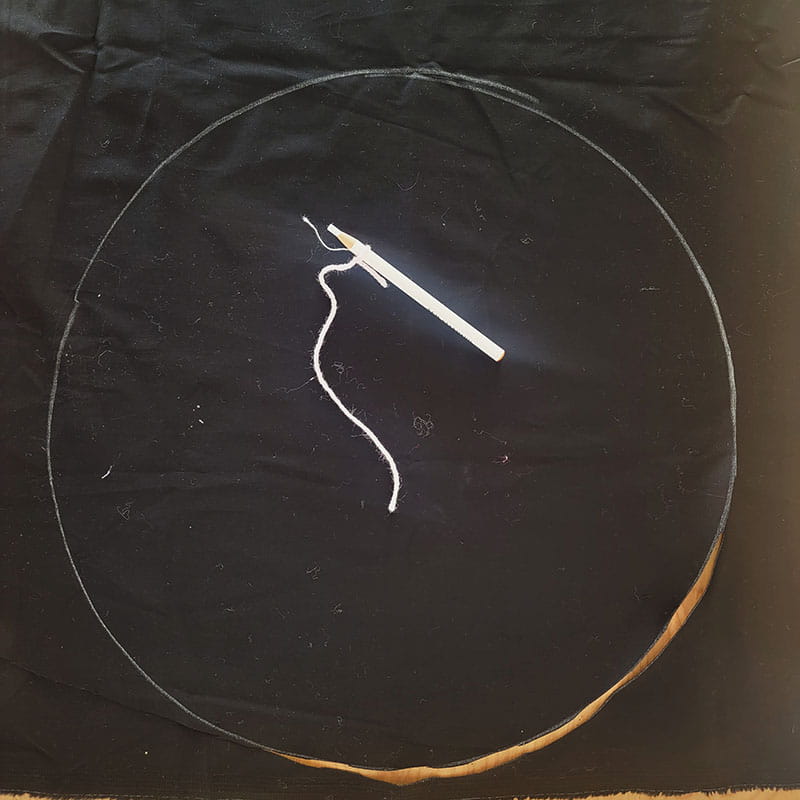 Needle with thread in the middle of a circle