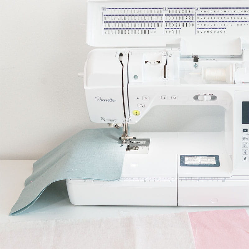 Blue fabric flower pot being sewn on a Brother sewing machine.