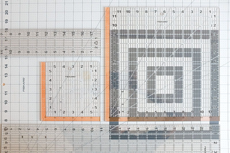 Various transparent rulers on a cutting board