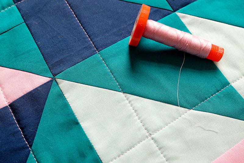 Quilt with thread holder on top of it
