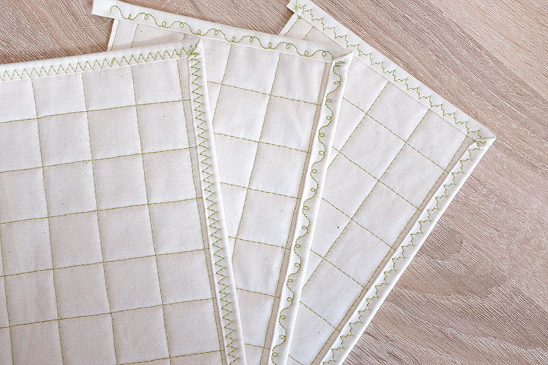 Sheets of quilt on wooden floor