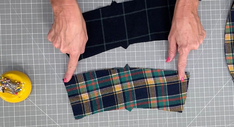 hands poining at the edges of the middle piece of fabric