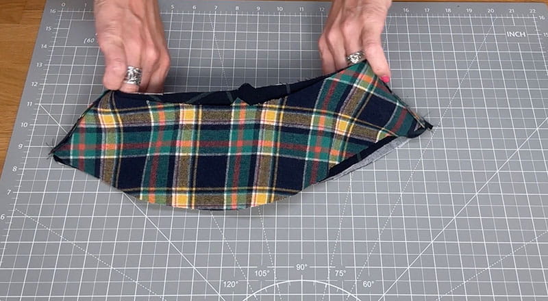 hands holding the cloth displaying the colors of the flannel