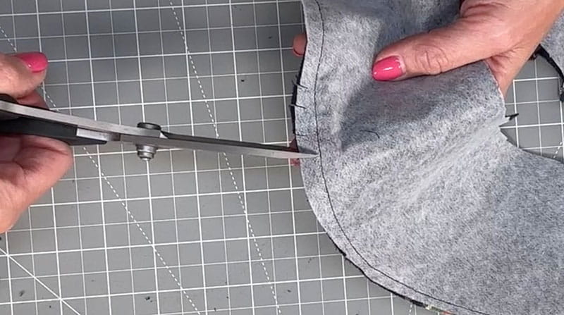scissors cutting the fabric close to the seam of the fabric