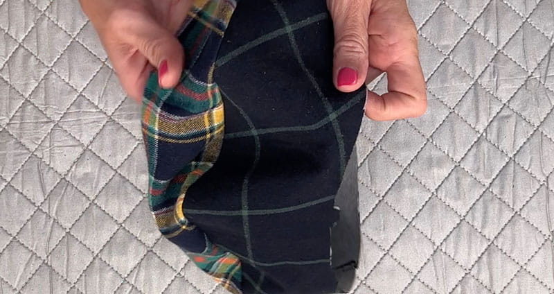 hands holding cloth displaying both sides of the cloth