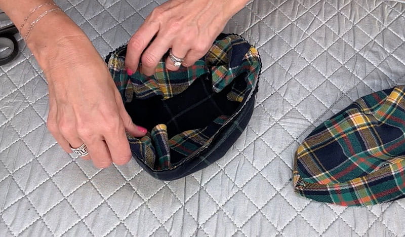 hands holding bucket hat turning the brim inside of middle section