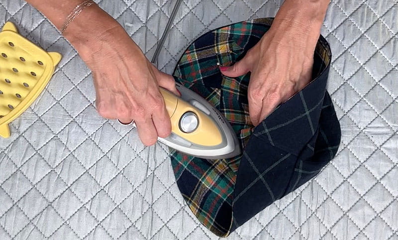 Pressing the bucket hat with an iron
