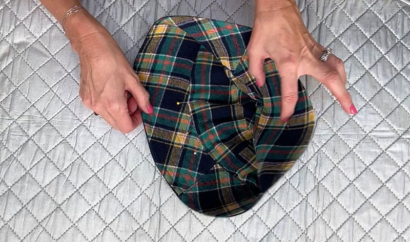 Hands holding sewed bucket hat white background