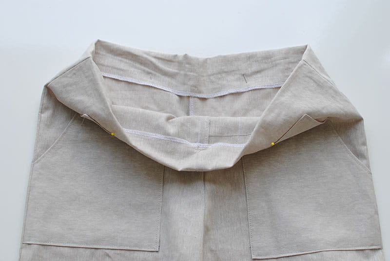 Opening the pants to show the waist