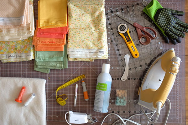 Quilting supplies and accessories on a cutting mat