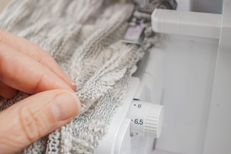 Stretching the fabric out while connected to the sewing machine