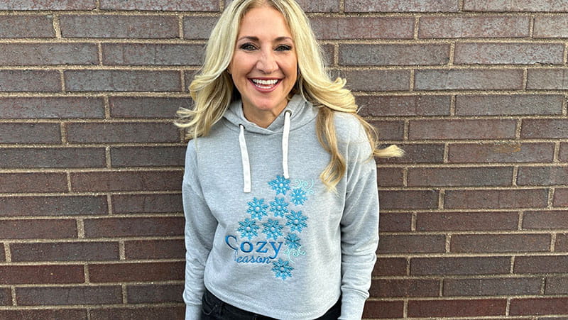 Girl in embroidery grey sweatshirt