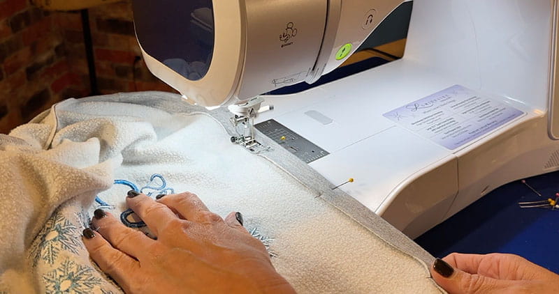 Stitching on grey sweatshirt from embroidery machine