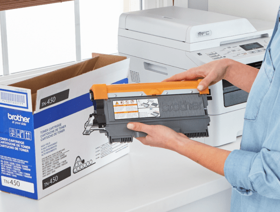 Person holding Brother toner cartridge