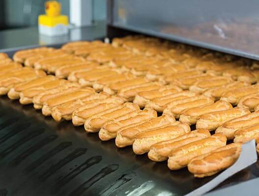 Bread exiting a commercial oven 