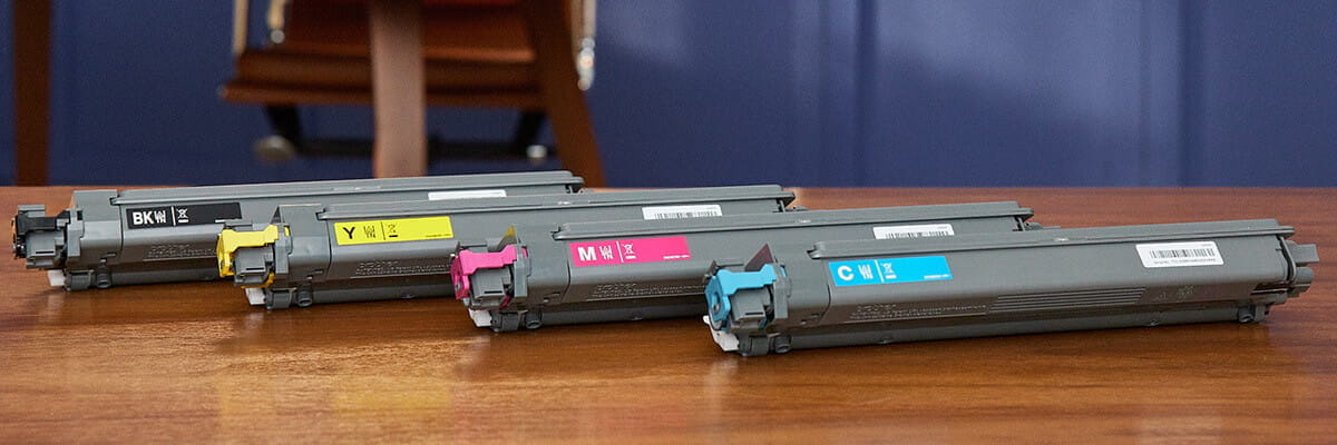 Brother toner cartridges on a wooden desk 