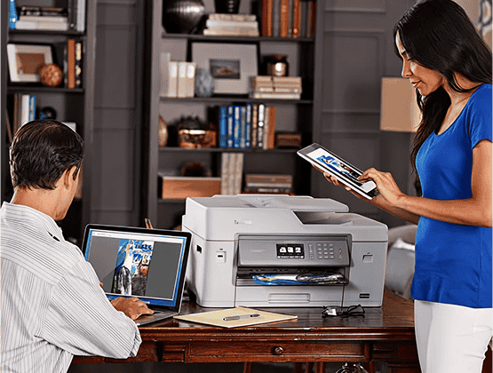 Guy using a Laptop and Woman with iPad using Brother IPrint and Scan