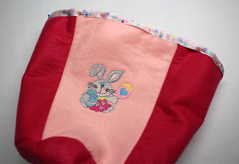Easter Basket 37-Pin to the top edge of the basket. Stitch along the edge of the ribbon.