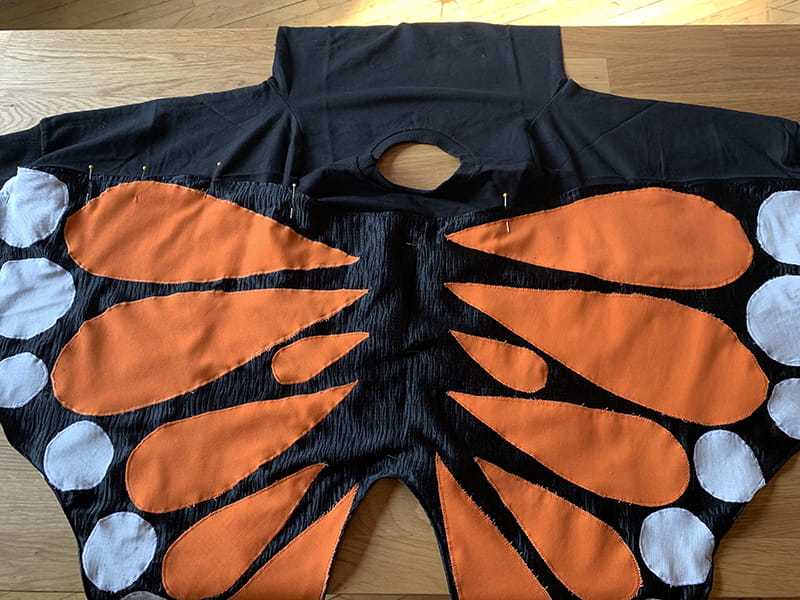 Pin wings on sweatshirt