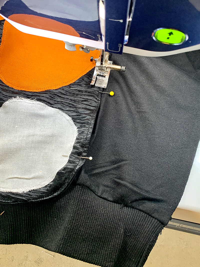 Sew wings to sweatshirt
