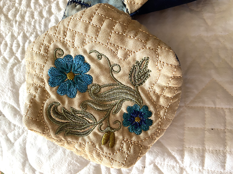 embroidered flower design on quilt