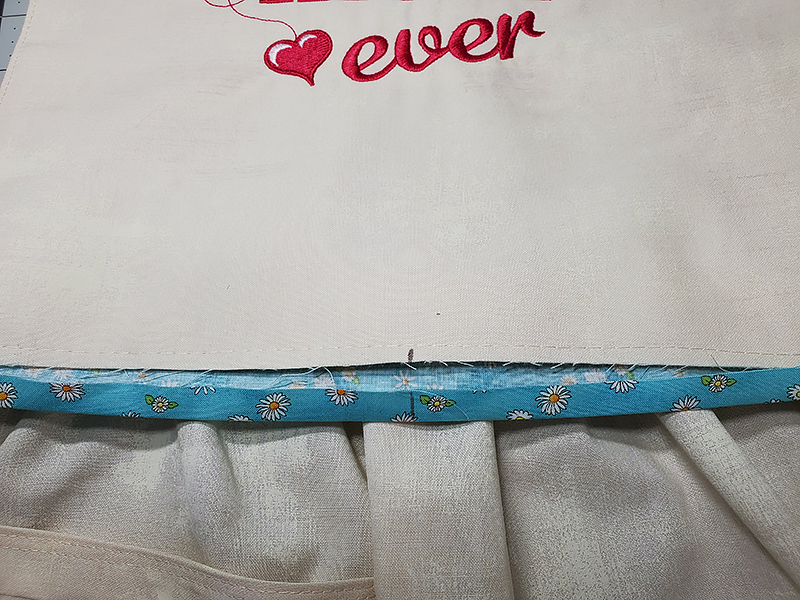 match center of N with center of apron bib